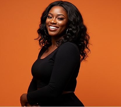 Black woman smiling in black top